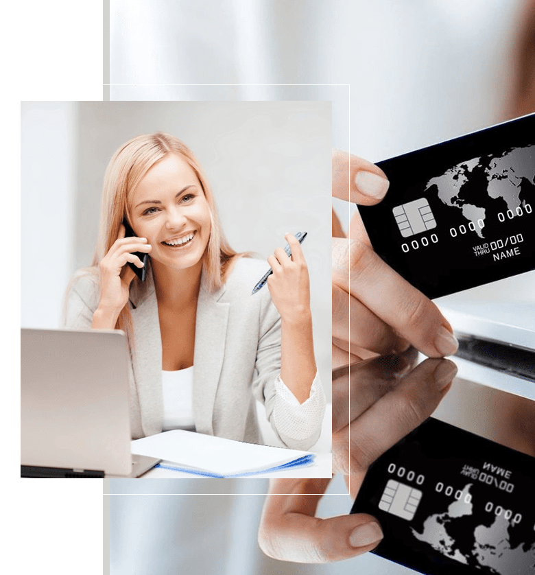 A woman talking on the phone and holding up her credit card.