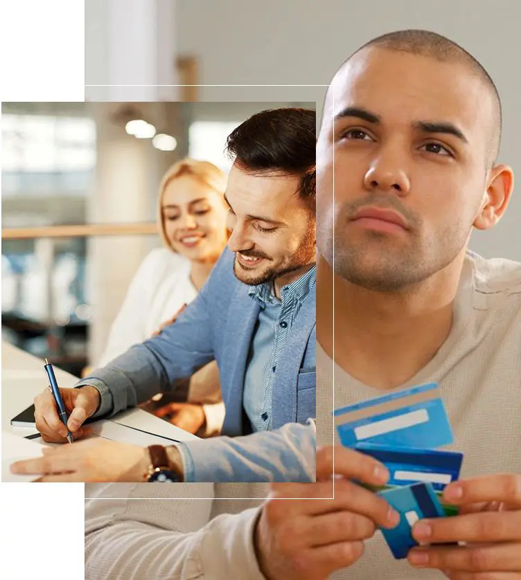 A man holding a credit card in front of two other people.